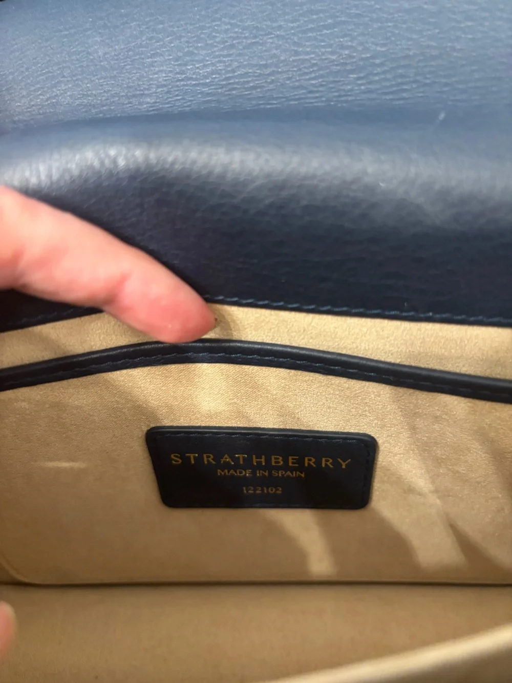 Strathberry blue, cream, and tan crossbody bag with gold hardware